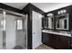 Nicely appointed bathroom featuring dual sinks, a walk-in shower, and dark modern cabinetry at 7628 Summer Berry Ln, Lithonia, GA 30038