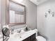 Bathroom featuring a large mirror, single sink, and a shower/tub combo at 7628 Summer Berry Ln, Lithonia, GA 30038