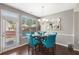 Cozy dining area with stylish chairs, elegant lighting, and a door to the outdoors at 7628 Summer Berry Ln, Lithonia, GA 30038