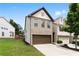 Exterior elevation of the home showcasing a brick and siding facade and two-car garage at 7628 Summer Berry Ln, Lithonia, GA 30038
