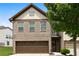 Charming two-story home with brick facade and a two-car garage, complemented by mature trees at 7628 Summer Berry Ln, Lithonia, GA 30038