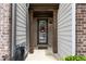 Inviting entrance with a decorative wreath on the door and well-maintained columns at 7628 Summer Berry Ln, Lithonia, GA 30038