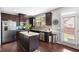 Modern kitchen boasts stainless steel appliances, granite countertops, and hardwood floors at 7628 Summer Berry Ln, Lithonia, GA 30038
