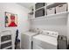 Laundry room with washer, dryer, and plenty of shelving at 7628 Summer Berry Ln, Lithonia, GA 30038