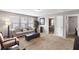Bright living room features large windows, neutral colors, and comfortable seating at 7628 Summer Berry Ln, Lithonia, GA 30038