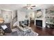 Cozy living room with a fireplace, hardwood floors, and comfortable seating at 7628 Summer Berry Ln, Lithonia, GA 30038