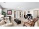 Spacious living room is furnished with a comfortable sofa, chairs, and a decorative ottoman at 7628 Summer Berry Ln, Lithonia, GA 30038