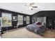 Stylish main bedroom boasts dark accents, a luxurious bed, and ample natural light at 7628 Summer Berry Ln, Lithonia, GA 30038