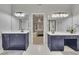 Well-lit bathroom with dual vanities and mirrors, adjacent to the main bedroom at 809 Hillcrest Ln, Woodstock, GA 30189