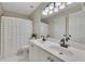 Bright bathroom with a double sink vanity, white cabinets, and modern fixtures at 809 Hillcrest Ln, Woodstock, GA 30189