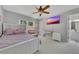 Spacious bedroom featuring modern amenities, including a ceiling fan and television at 809 Hillcrest Ln, Woodstock, GA 30189