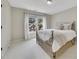 Cozy bedroom features a wrought iron bed frame and large window providing natural light at 809 Hillcrest Ln, Woodstock, GA 30189