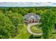 Beautiful aerial view of clubhouse with golf course, lush landscaping, and winding driveway at 809 Hillcrest Ln, Woodstock, GA 30189