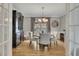 Formal dining room with modern light fixture, hardwood flooring and a window view of the outdoors at 809 Hillcrest Ln, Woodstock, GA 30189