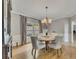 Dining room with hardwood floors, modern chandelier, and view of the outdoors at 809 Hillcrest Ln, Woodstock, GA 30189