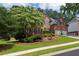 Beautifully landscaped brick home featuring a well-manicured lawn and mature trees at 809 Hillcrest Ln, Woodstock, GA 30189
