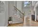 Bright foyer featuring a staircase with wooden handrail and a stylish console table at 809 Hillcrest Ln, Woodstock, GA 30189