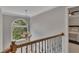 Hallway with a view into a bedroom and natural light streaming through the arched window at 809 Hillcrest Ln, Woodstock, GA 30189