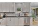 Bright kitchen with granite counters, stainless steel appliances, and white cabinetry at 809 Hillcrest Ln, Woodstock, GA 30189