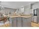 Kitchen island with granite countertop, stainless steel refrigerator, and hardwood floors at 809 Hillcrest Ln, Woodstock, GA 30189