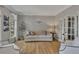Bright living room featuring hardwood floors, neutral paint, and french doors leading to another room at 809 Hillcrest Ln, Woodstock, GA 30189
