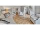 Open living room with hardwood floors, leading to a staircase and another sitting room at 809 Hillcrest Ln, Woodstock, GA 30189