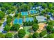 Aerial view of multiple tennis courts, basketball court, and playground in a wooded community at 809 Hillcrest Ln, Woodstock, GA 30189