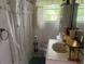 Small bathroom with patterned shower curtain, basic sink, and patterned floor tiles at 10199 Starr Sw St, Covington, GA 30014