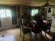Inviting dining room with large windows and ceiling fan, providing a comfortable eating space at 10199 Starr Sw St, Covington, GA 30014