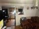 Cozy living room featuring hardwood floors, a decorative couch, and an open view to the kitchen at 10199 Starr Sw St, Covington, GA 30014