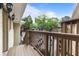 This image showcases a cozy balcony, with the wooden railing, and lush trees in the background at 1879 Johnson Ne Rd # 10, Atlanta, GA 30306