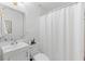 Bathroom featuring white fixtures, a shower with a white curtain, and a framed mirror at 1879 Johnson Ne Rd # 10, Atlanta, GA 30306