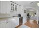 Bright kitchen featuring white cabinets, stainless steel dishwasher, and an open layout to the living area at 1879 Johnson Ne Rd # 10, Atlanta, GA 30306