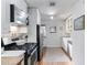 Well-lit kitchen with stainless steel appliances, white cabinetry, and stylish rug, creating a modern space at 1879 Johnson Ne Rd # 10, Atlanta, GA 30306