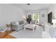 Bright living room with white walls, hardwood floors, a stylish sofa, and French doors that amplify the natural light at 1879 Johnson Ne Rd # 10, Atlanta, GA 30306