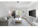 Bright living room with white walls, hardwood floors, a stylish sofa, and modern TV that enhances the appeal at 1879 Johnson Ne Rd # 10, Atlanta, GA 30306