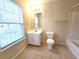 Bright bathroom with tile floors, a vanity with mirror, and a shower-tub combination at 2104 Meadow Peak Rd, Duluth, GA 30097