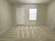 Neutral bedroom with a window letting in natural light, and a door on the back wall at 2104 Meadow Peak Rd, Duluth, GA 30097