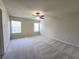 Large carpeted bedroom with natural light from two windows and ceiling fan at 2104 Meadow Peak Rd, Duluth, GA 30097