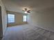 Large bedroom with neutral carpet, a ceiling fan, and two windows at 2104 Meadow Peak Rd, Duluth, GA 30097