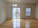 Dining area with hardwood floors and a sliding glass door leading to an outdoor space at 2104 Meadow Peak Rd, Duluth, GA 30097