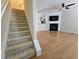 View of the entry, featuring wood floors, stairs, and a fireplace in the living room at 2104 Meadow Peak Rd, Duluth, GA 30097