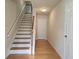 Inviting entryway with hardwood floors, a staircase, and neutral wall paint at 2104 Meadow Peak Rd, Duluth, GA 30097