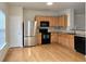 Modern kitchen with stainless steel appliances, granite countertops, and hardwood flooring at 2104 Meadow Peak Rd, Duluth, GA 30097