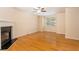 Bright living room featuring hardwood floors, a ceiling fan, and a fireplace at 2104 Meadow Peak Rd, Duluth, GA 30097