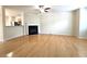Open-concept living room with hardwood floors and fireplace at 2104 Meadow Peak Rd, Duluth, GA 30097