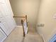 Carpeted staircase with wooden banister and white walls, leading to the upper level at 2104 Meadow Peak Rd, Duluth, GA 30097