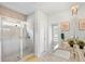 A full bathroom features a glass-enclosed shower and double vanity with granite counters at 230 Fender Walk, Marietta, GA 30060