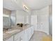 A full bathroom features a glass-enclosed shower, and double vanity with white cabinets and granite counters at 230 Fender Walk, Marietta, GA 30060