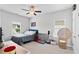 This bedroom features a bed, desk, and rattan chair at 230 Fender Walk, Marietta, GA 30060